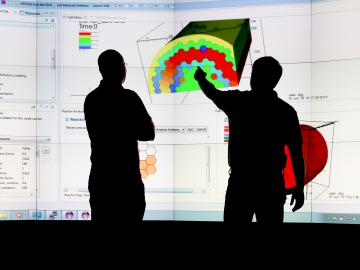 Jay Jay Billings and Alex McCaskey observe visualizations of ICE simulation data on ORNL’s Exploratory Visualization Environment for Research in Science and Technology facility. Credit: Jason Richards/ORNL