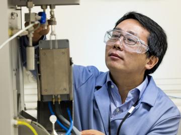 Chemist Zili Wu makes discoveries about catalysts using a suite of sophisticated tools, such as this adsorption microcalorimeter to probe catalytic sites. Image credit: Oak Ridge National Laboratory, U.S. Dept. of Energy; photographer Carlos Jones