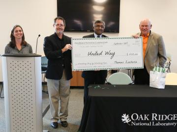 Former University of Tennessee football coach Phillip Fulmer (right) helps ORNL celebrate $858,000 of contributions to this year’s United Way campaign. Former University of Tennessee football coach Phillip Fulmer (right) helps ORNL celebrate $858,000 of contributions to this year’s United Way campaign.