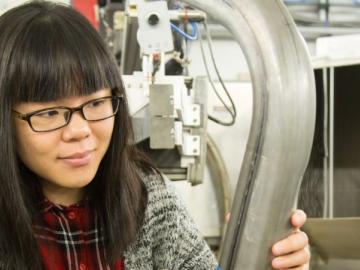 Lu Huang, USS industrial research engineer prepares a lightweighted advanced high strength steel component for neutron research at the Spallation Neutron Source’s VULCAN instrument. 