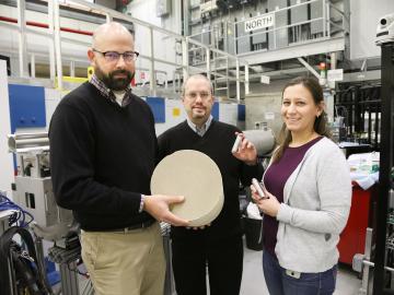 ORNL researchers Todd Toops, Charles Finney, and Melanie DeBusk (left to right) hold an example of a particulate filter used to collect harmful emissions in vehicles. ORNL researchers Todd Toops, Charles Finney, and Melanie DeBusk (left to right) hold an example of a particulate filter used to collect harmful emissions in vehicles.
