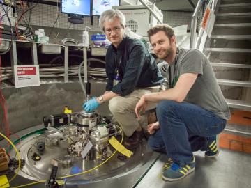 Doug Abernathy, left, ARCS instrument scientist at Oak Ridge National Laboratory, and Marc Janoschek, Los Alamos National Laboratory, prepare their sample for experiments at the Spallation Neutron Source.