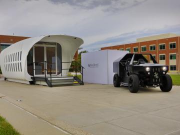 Oak Ridge National Laboratory's Additive Manufacturing Integrated Energy  (AMIE) demonstration connects a 3D-printed building and vehicle to showcase a new approach to energy use, storage and consumption. Photo by Carlos Jones