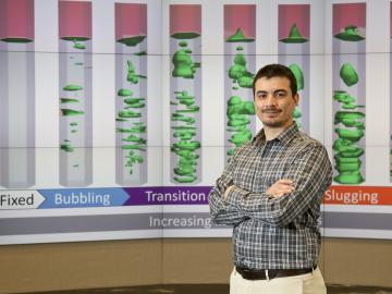 Emilio Ramirez studies the slugging transition in a bench scale reactor made possible by the Computational Pyrolysis Consortium, a multilaboratory collaboration formed to develop infrastructure ready fuel from biomass feedstock.