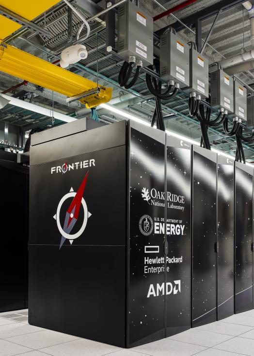 Image of Frontier supercomputer showing the endcap logo and first row of cabinets.