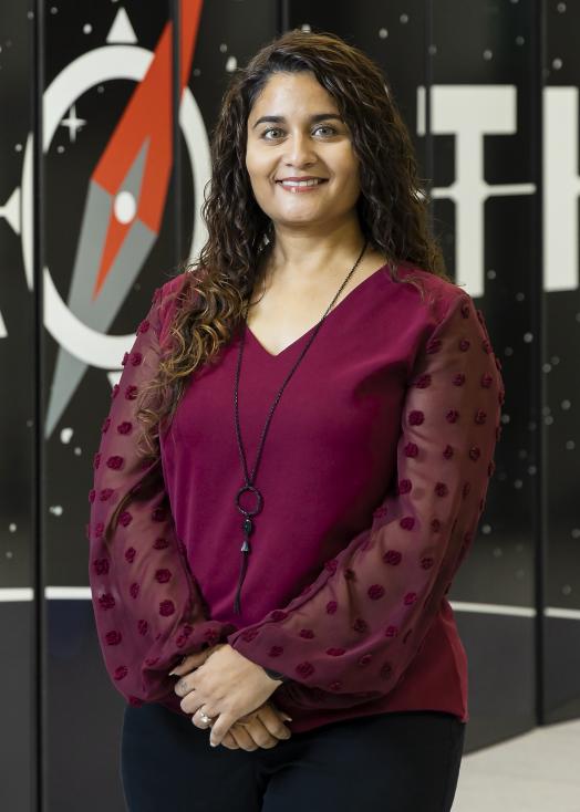 Addi Malviya Thakur in front of Frontier supercomputer 