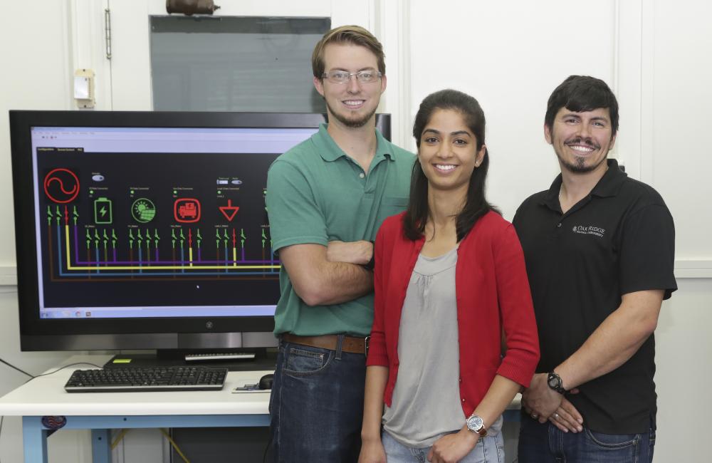 Ben Ollis, Ishita Ray, and Phil Irminger in a Power and Energy Systems group laboratory with SI-GRID components.