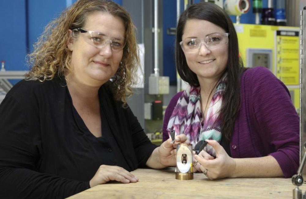 Bianca Haberl and Amy Elliott hold 3d printed collimators 