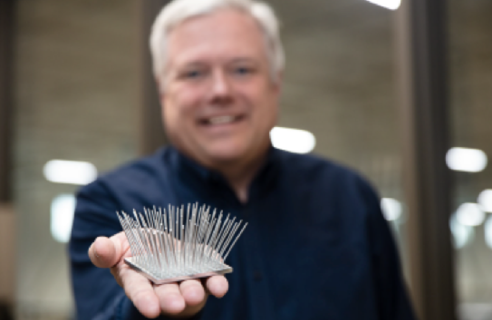 Scott Smith holding machined aluminum part