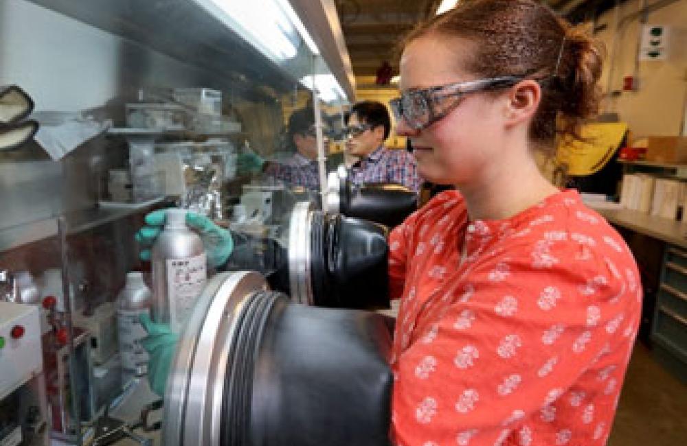 Researcher Marissa Wood assembles prototype coin cells in an Ar glove box for studying electrode manufacturing process improvements 