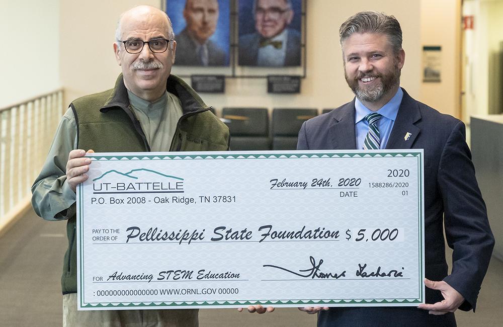 Moe Khaleel (left), associate laboratory director of ORNL's Energy and Environmental Sciences Directorate, presents a symbolic check to Pellissippi State Community College President L. Anthony Wise Jr.