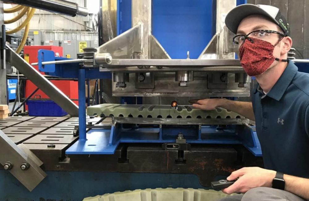 A Climax technician works on a shear pin drill fixture, a critical tool used to prevent rotational movement among the central solenoid superconducting magnets. Photo: Climax