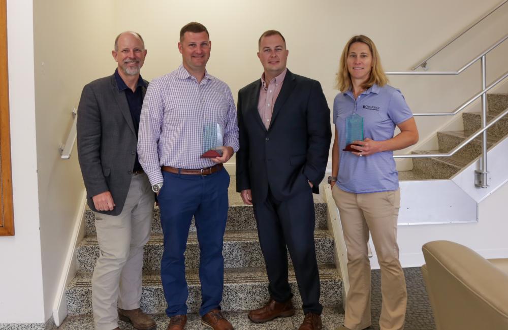 From left, Craig Moss, Major Micah McCracken, Tim Delk and Lt. Col. Jessica Critcher pose with awards given at a small ceremony recognizing ORNL’s 2022 military fellows. Credit: Genevieve Martin/ORNL, U.S. Dept. of Energy