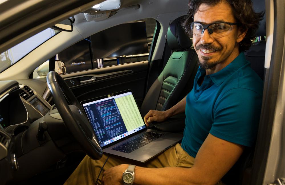 Bobby Bridges sits in the driver's seat of a car