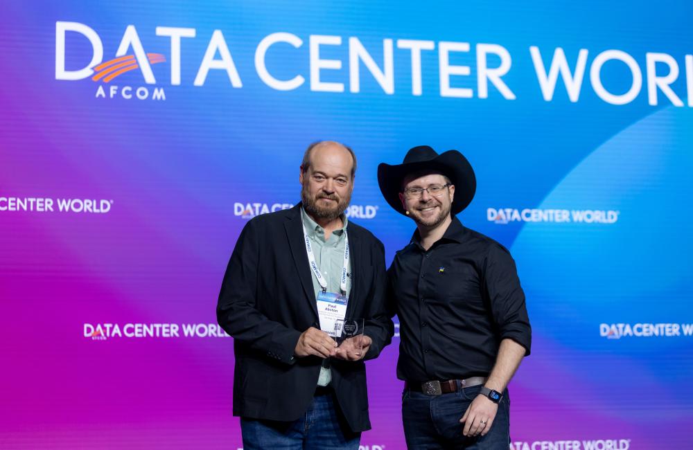 Data Center World keynote presenter, Bill Kleyman, right, presented ORNL’s Paul Abston with the Data Center Manager of the Year 2023 award during the conference’s general session on May 9. Credit: Data Center World AFCOM