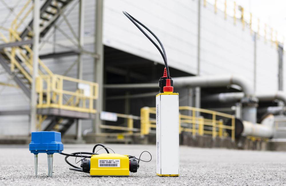 ORNL seismic researcher Chengping Chai placed seismic sensors on the ground at various distances from an ORNL nuclear reactor to learn whether they could detect its operating state. Credit: Carlos Jones/ORNL, U.S. Dept. of Energy