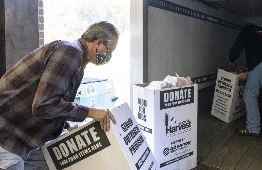 Volunteer loading boxes for Second Harvest