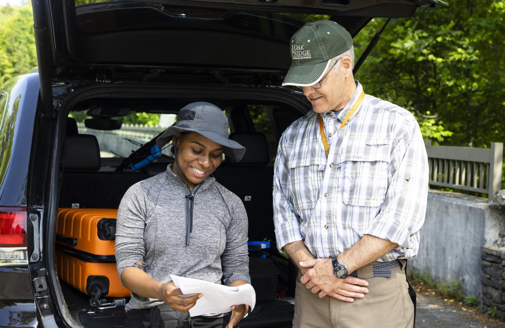 From left, Gladisol Smith Vega prepares to collect field data on the Oak Ridge Reservation with mentor Scott Brooks. Credit: Carlos Jones/ORNL. U.S. Dept. of Energy