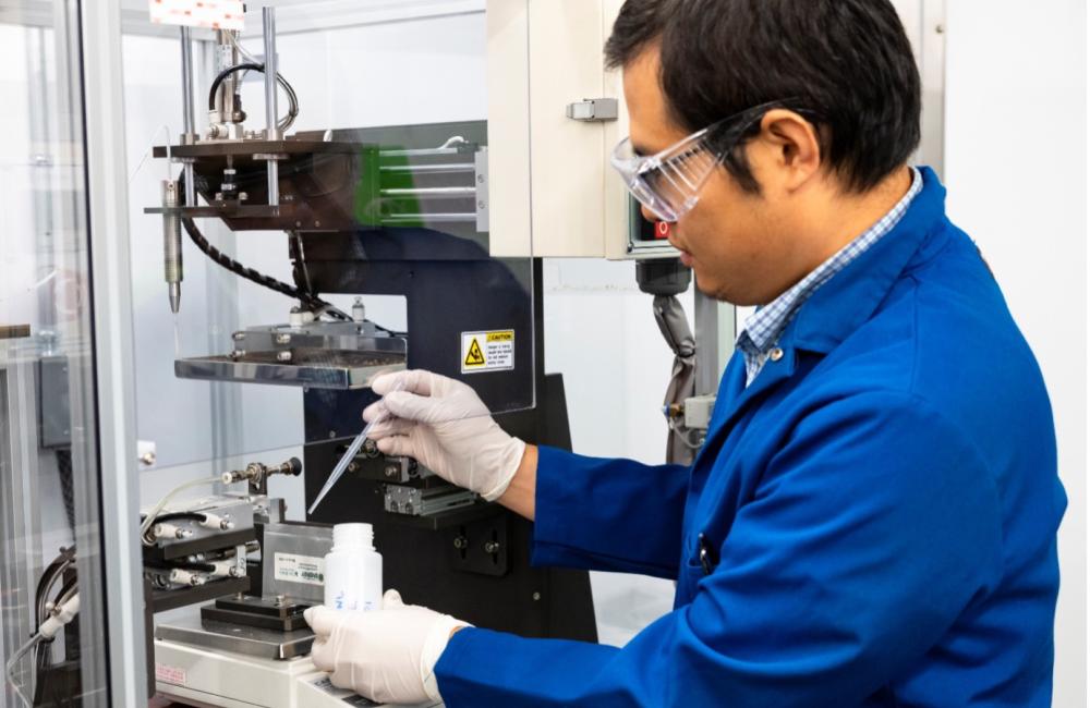 ORNL researcher Zhijia Du inserts a newly developed liquid electrolyte material into a battery pouch cell. The formulation extends the life of extreme-fast-charging batteries like those used in electric vehicles. Credit: Genevieve Martin/ORNL, U.S. Dept. of Energy