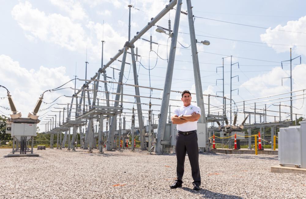 Man stands in front of power lines