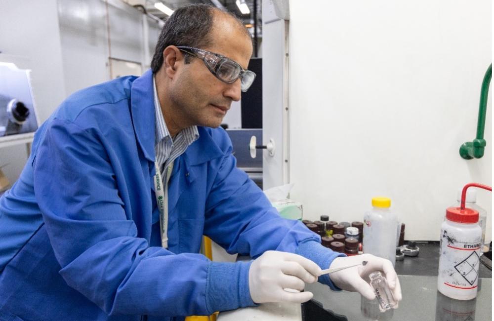 Caption: Jaswinder Sharma makes battery coin cells with a lightweight current collector made of thin layers of aligned carbon fibers in a polymer with carbon nanotubes. Credit: Genevieve Martin/ORNL, U.S. Dept. of Energy