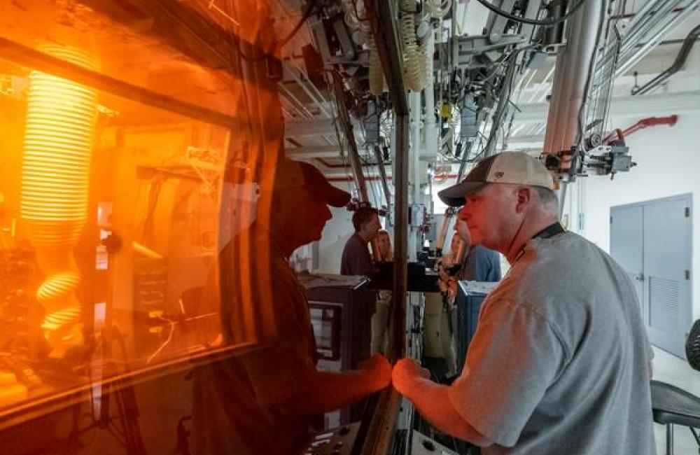 Leaders value the safety legacy they create in their discipline - Sam Schrell and 3 team members working with manipulators in hot cell face for Cf-252, May 28, 2021.