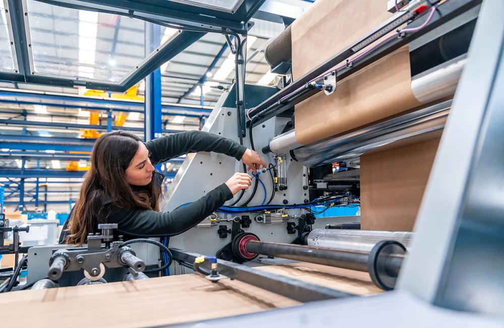Engineer working on a machine making packaging. Envato