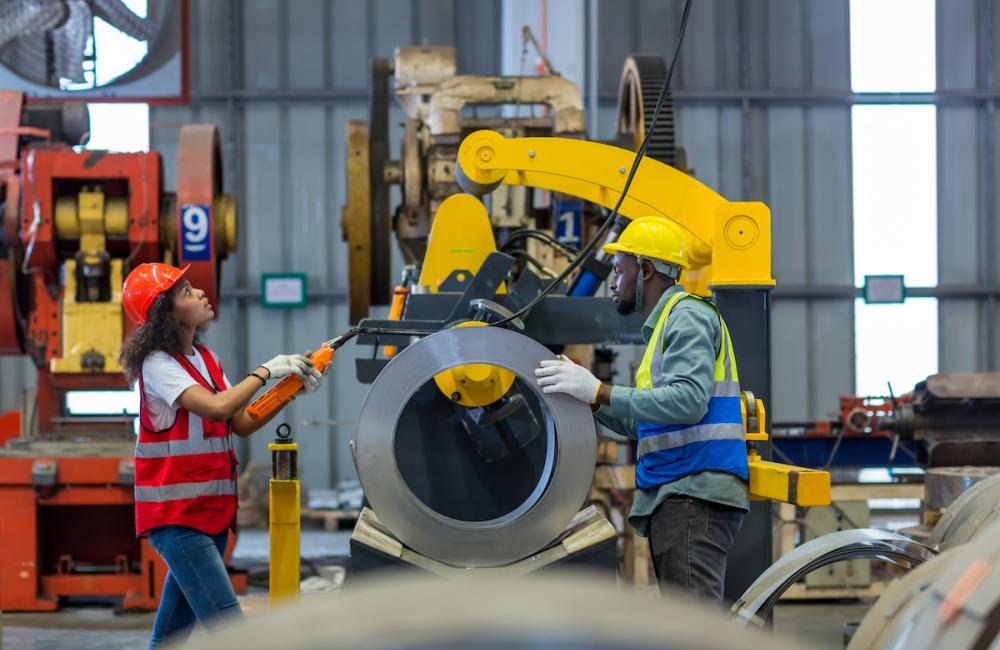 Foreman or worker work at factory site check up machine or products in site.  Image from Envato