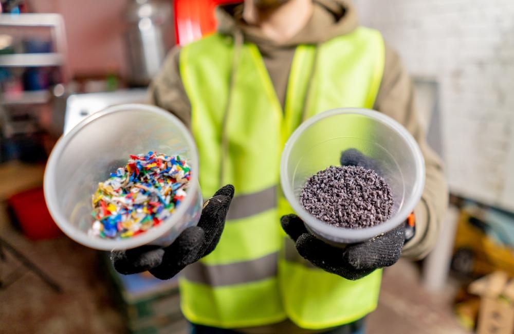 Close-up shot of shredded plastic bottle caps for further recycling at a waste recycling plant. Image from Envato
