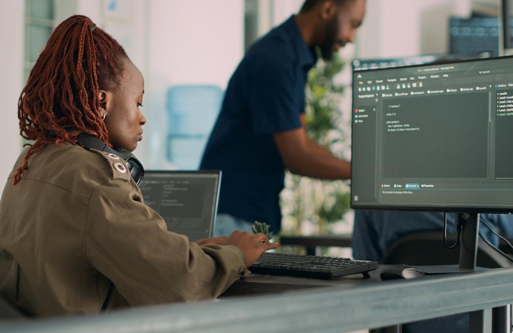 Software developer typing programming code on computer to develop online cloud computing information. Image from Envato