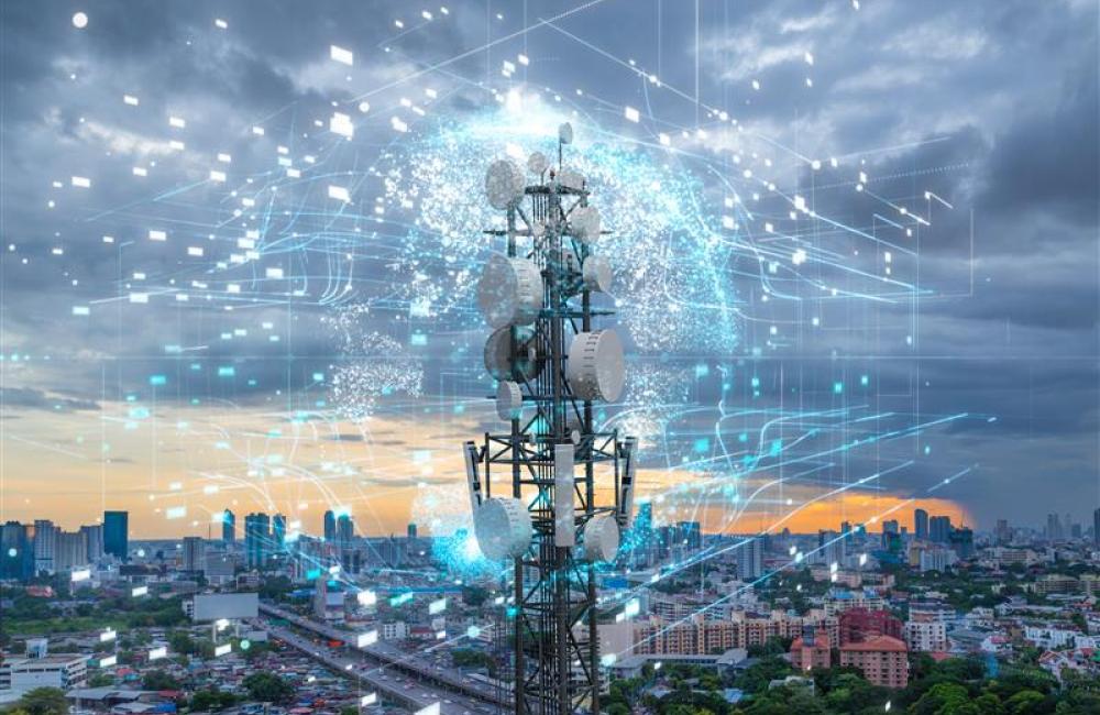 Telecommunication tower with city background. Image from Adobe Stock.