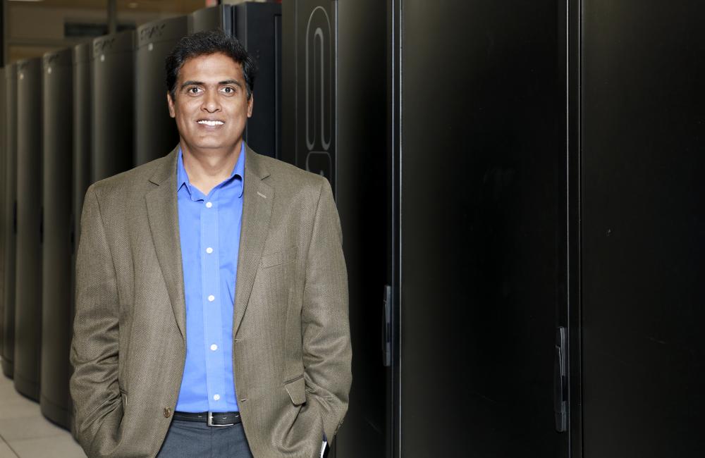 Giri Prakash stands with the Cumulus computing cluster that he established with colleagues in the Oak Ridge Leadership Computing Facility for scientists to use in analyzing ARM data.