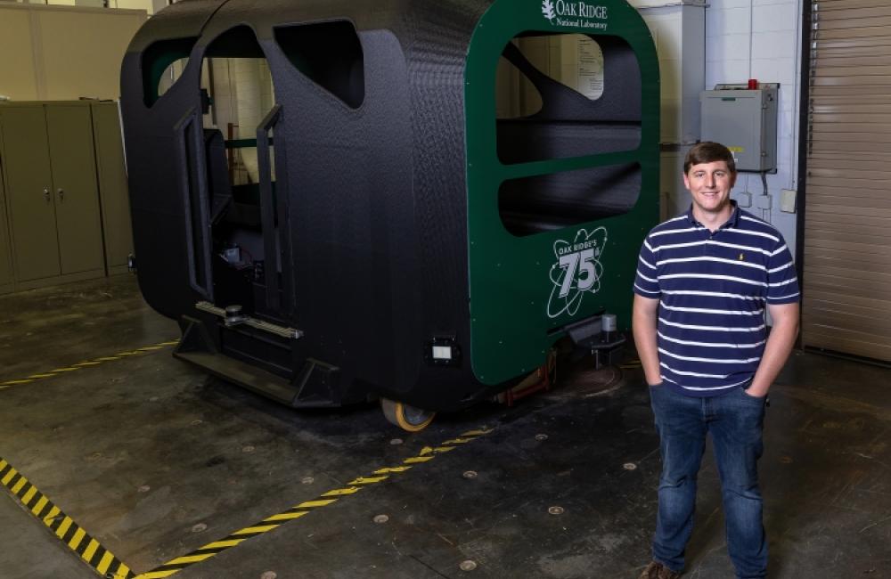 Dean Deter, part of the research team for ORNL’s first autonomous bus, pictured with GROVER at the National Transportation Research Center.