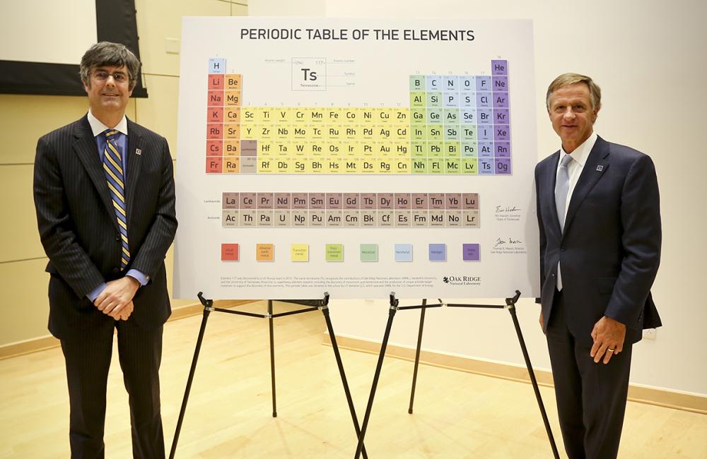 ORNL Director Thom Mason, left, and Tennessee Gov. Bill Haslam stand beside the updated periodic table including tennessine, Ts, located on the next to last row from the bottom and third from the right. (ORNL photo by Jason Richards) 