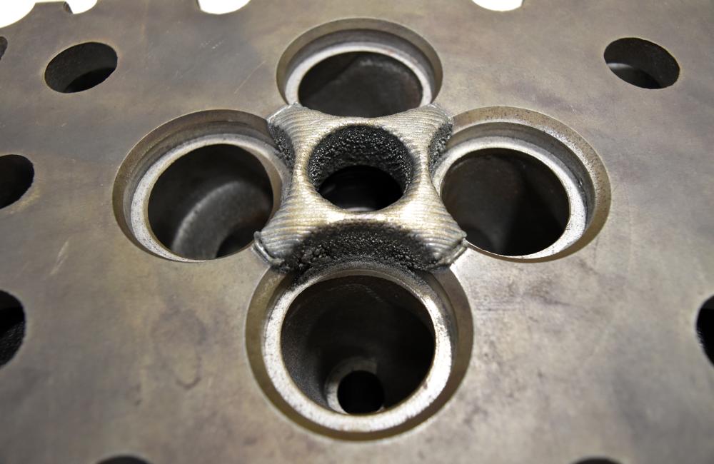 A 3D printing process developed at Oak Ridge National Laboratory repairs and strengthens a Cummins engine without the need to recast parts, which reduces costs and saves energy. Credit: Brittany Cramer/Oak Ridge National Laboratory, U.S. Dept. of Energy