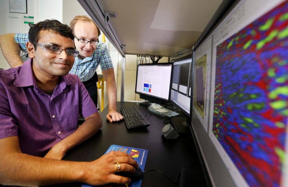 ORNL’s Sergei Kalinin and Rama Vasudevan (far left) used scanning probe microscopy to discover inseparable interplay between bulk ferroelectricity and surface electrochemistry in a 30-nanometer-thick film of barium titanate.