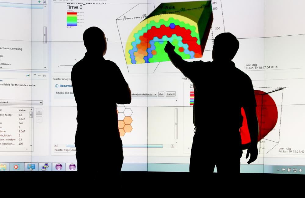 Jay Jay Billings and Alex McCaskey observe visualizations of ICE simulation data on ORNL’s Exploratory Visualization Environment for Research in Science and Technology facility. Credit: Jason Richards/ORNL