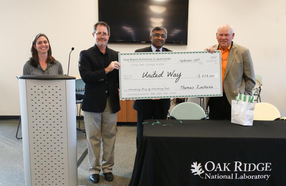 Former University of Tennessee football coach Phillip Fulmer (right) helps ORNL celebrate $858,000 of contributions to this year’s United Way campaign.