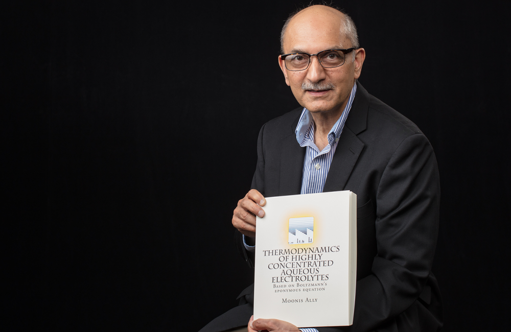 ORNL researcher Moonis Ally with his published theory: "Thermodynamics of Highly Concentratied Aqueous Electrolytes."