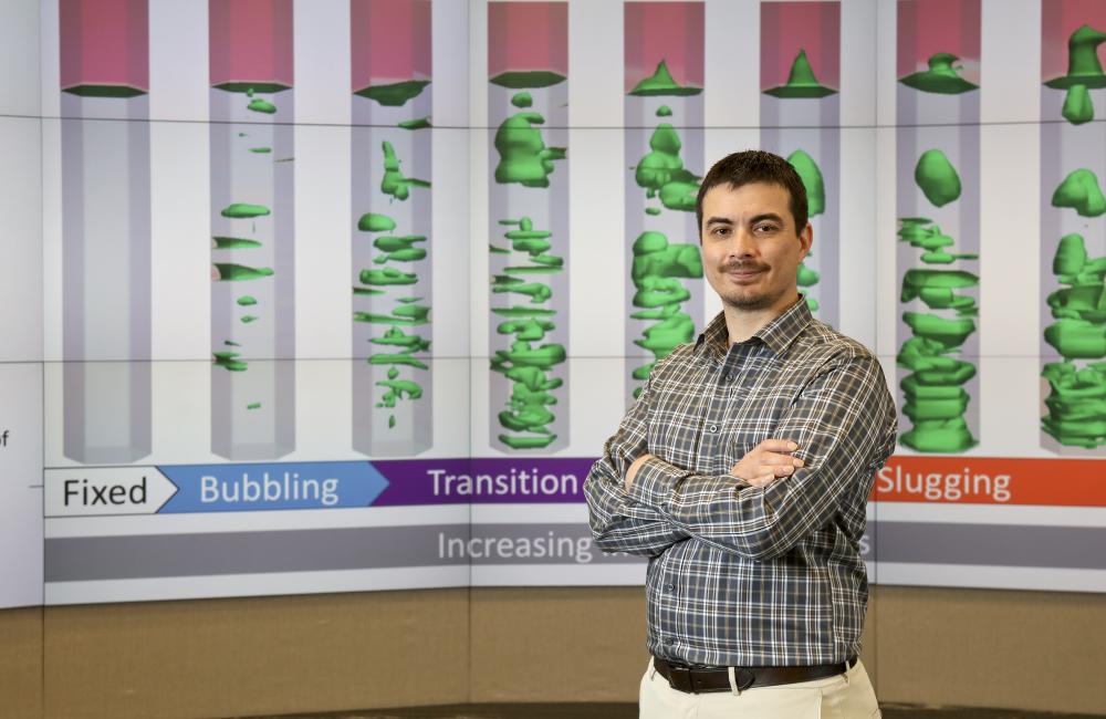 Emilio Ramirez studies the slugging transition in a bench scale reactor made possible by the Computational Pyrolysis Consortium, a multilaboratory collaboration formed to develop infrastructure ready fuel from biomass feedstock.