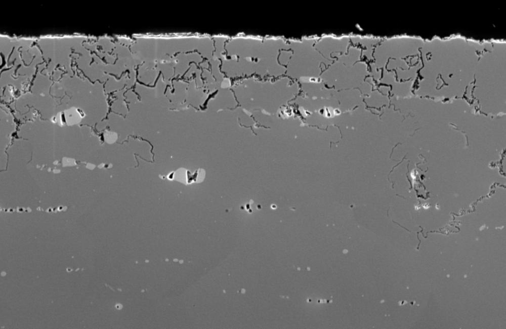 At the salt–metal interface, thermodynamic forces drive chromium from the bulk of a nickel alloy, leaving a porous, weakened layer. Impurities in the salt drive further corrosion of the structural material. Credit: Stephen Raiman/Oak Ridge National Labora