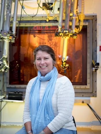 Julie Ezold sits in front of the Radiochemical Engineering Development Center’s Hot Cell G, where Caiifornium-252 is processed. Ezold led the 2008 revival of ORNL’s Cf-252 program. Credit: Carlos Jones/ORNL, U.S. Dept. of Energy