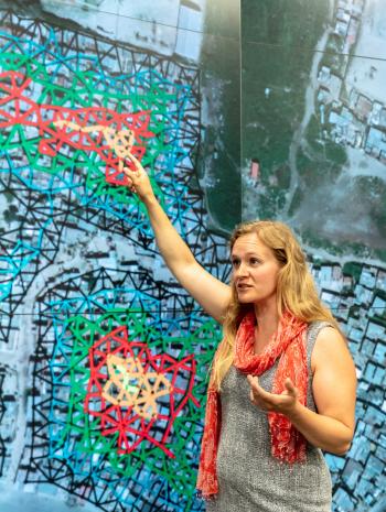 ORNL research scientist Christa Brelsford explained a mathematical framework she developed in 2018, which showed increased availability of infrastructure didn't necessarily reduce inequality in its access. Credit: Carlos Jones/ORNL, U.S. Dept. of Energy