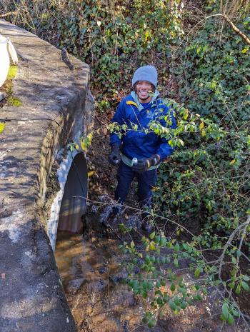 Dre Presswood, a Georgia State University master’s program student, samples a creek in Decatur, Georgia. He will join ORNL for a summer internship to study urban watersheds. Credit: Georgia State University