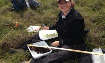 A woman conducts field research
