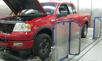 red truck with popped hood in testing facility
