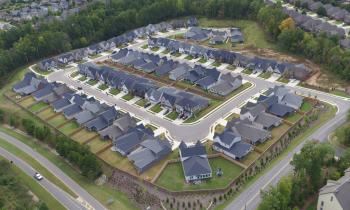 Aerial view of connected neighborhood showing rooftops and yards arranged in a square