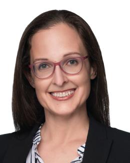 Headshot of woman with dark hair and glasses