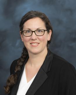 Professional head shot with hair braided to side