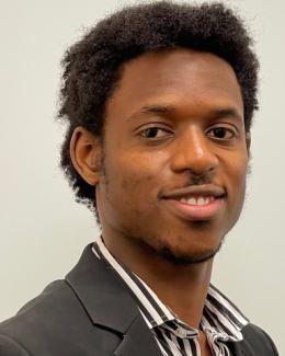 Headshot of Ajibola Lawal; wearing a black suit.